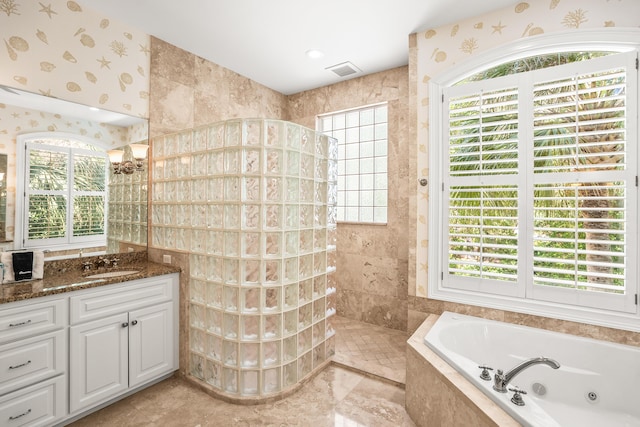 12 Port Tack, Hilton Head Island, SC 29928 - bathroom with plenty of natural light, a jetted tub, a walk in shower, vanity, and wallpapered walls