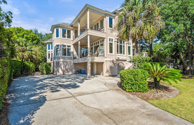 12 Port Tack, Hilton Head Island, SC 29928 - view of front of property featuring a balcony, concrete driveway, a garage, and stucco siding