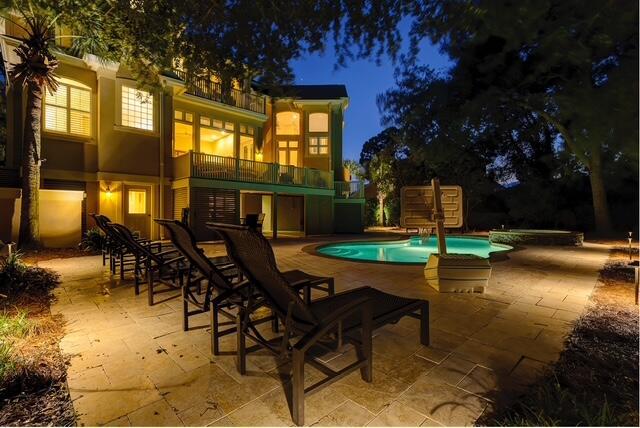 12 Port Tack, Hilton Head Island, SC 29928 - patio at twilight with a balcony, a patio, and an outdoor pool