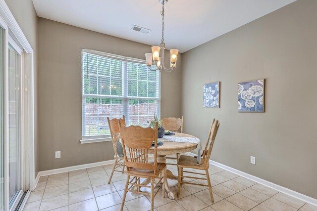 7690 High Maple Cir N, Charleston, SC 29418 - dining area featuring a chandelier, light tile patterned floors, and baseboards