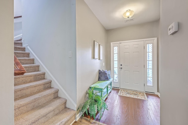 7690 High Maple Cir N, Charleston, SC 29418 - entryway with stairway, wood finished floors, and baseboards