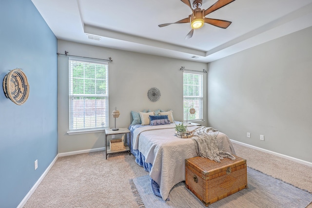 7690 High Maple Cir N, Charleston, SC 29418 - bedroom featuring a raised ceiling, multiple windows, and carpet