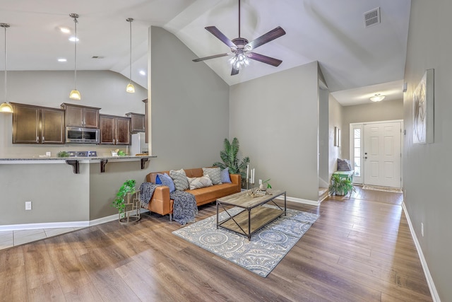 7690 High Maple Cir N, Charleston, SC 29418 - living area featuring high vaulted ceiling, wood finished floors, ceiling fan, and baseboards