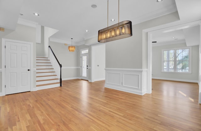 entryway with baseboards, light wood-style flooring, stairway, ornamental molding, and recessed lighting