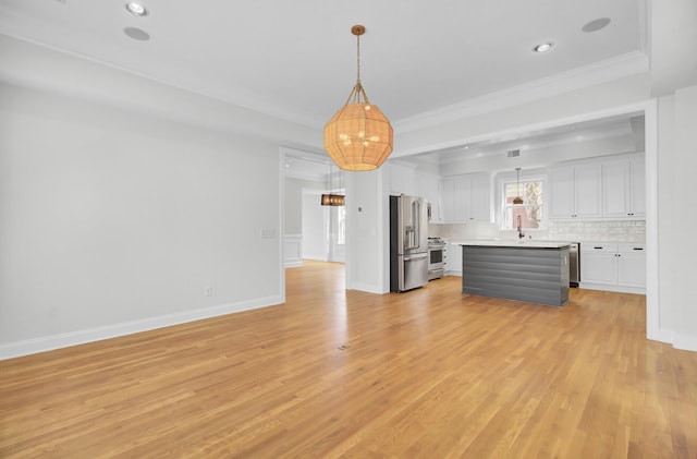 unfurnished living room with light wood-style flooring, recessed lighting, a sink, baseboards, and ornamental molding