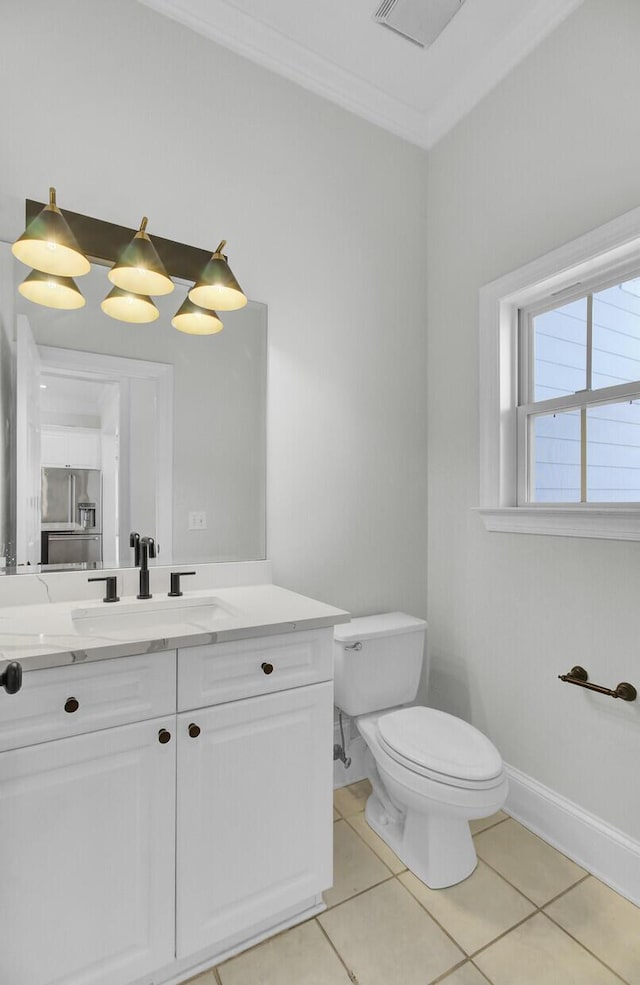 bathroom featuring baseboards, toilet, tile patterned flooring, crown molding, and vanity