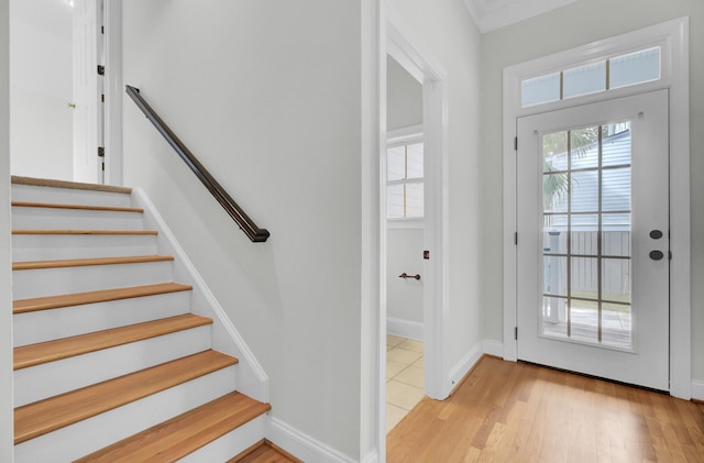 interior space with stairs, light wood finished floors, and baseboards