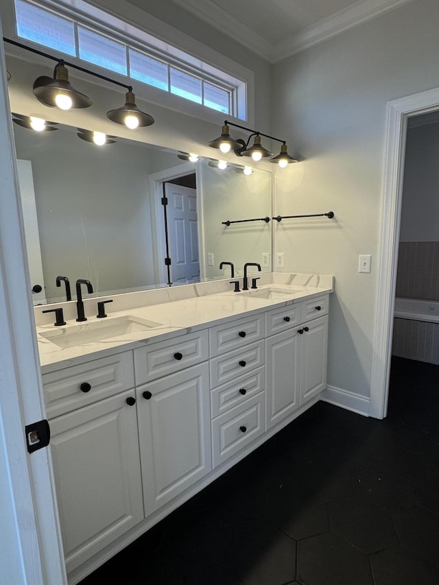 full bathroom featuring ornamental molding, a sink, baseboards, and double vanity