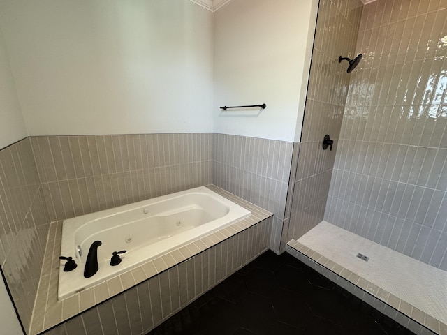 full bathroom featuring a whirlpool tub and a shower stall