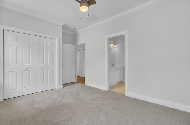 unfurnished bedroom featuring baseboards, visible vents, light colored carpet, ensuite bathroom, and crown molding