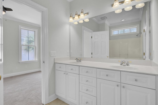 bathroom with double vanity, plenty of natural light, a sink, and crown molding