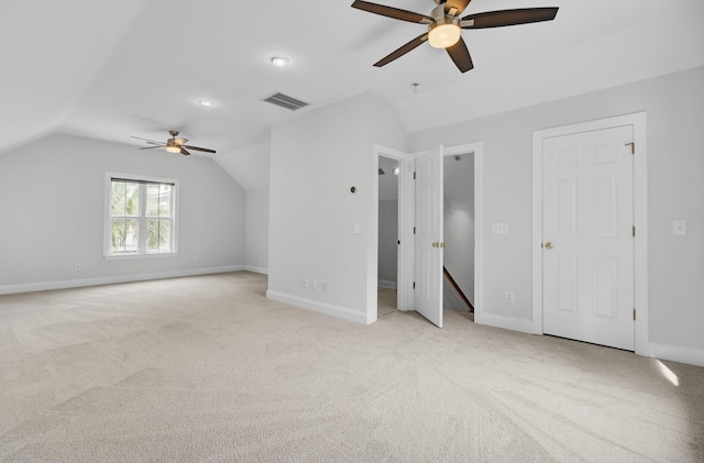 bonus room with light carpet, baseboards, visible vents, and vaulted ceiling