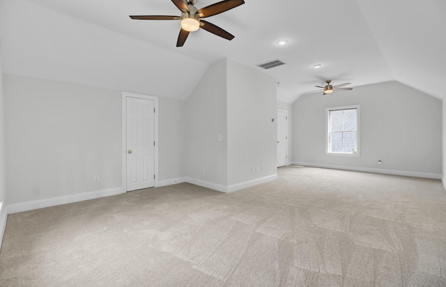 bonus room featuring light carpet, lofted ceiling, visible vents, and baseboards