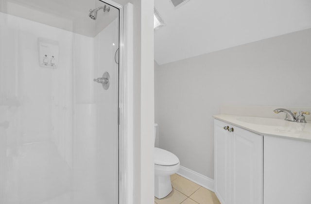 bathroom featuring toilet, a stall shower, vanity, and tile patterned floors