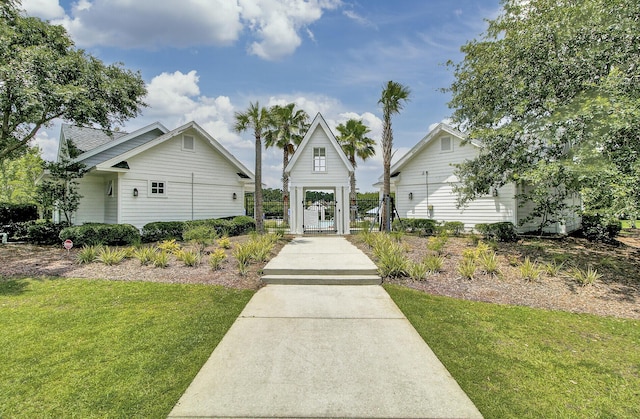 view of front of house with a gate, fence, and a front yard