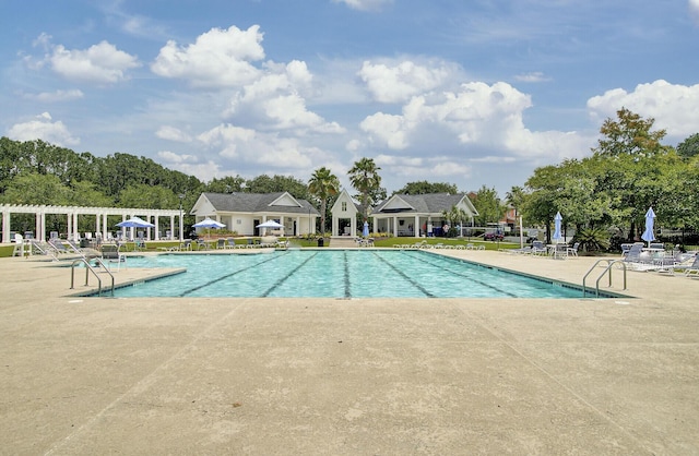 pool featuring fence, a pergola, and a patio