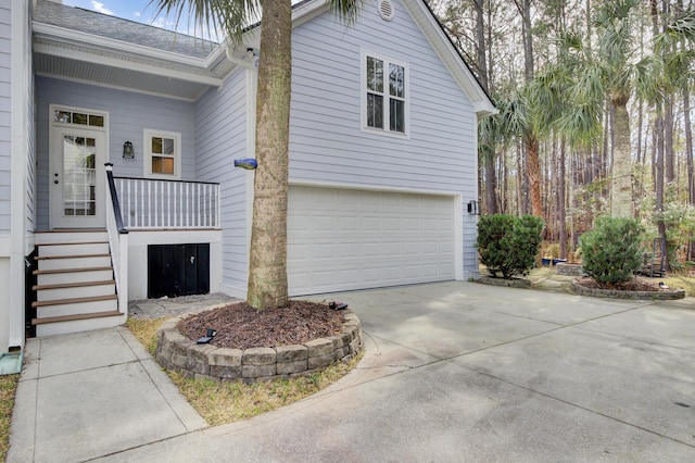 view of property exterior with an attached garage, driveway, stairs, and a shingled roof