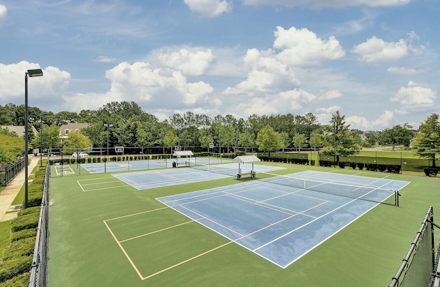 view of sport court featuring fence