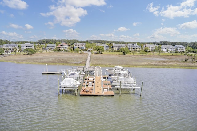 view of dock with a residential view and a water view