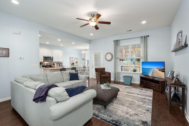 living room with ceiling fan and dark hardwood / wood-style floors