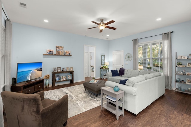 living room featuring dark hardwood / wood-style flooring and ceiling fan