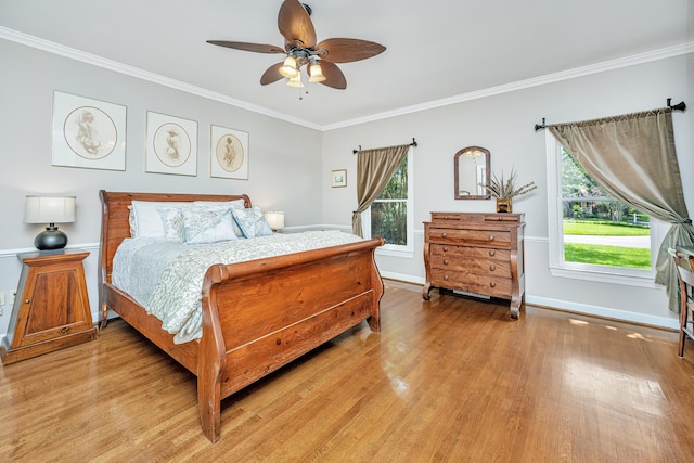 bedroom featuring light hardwood / wood-style flooring, ornamental molding, and ceiling fan