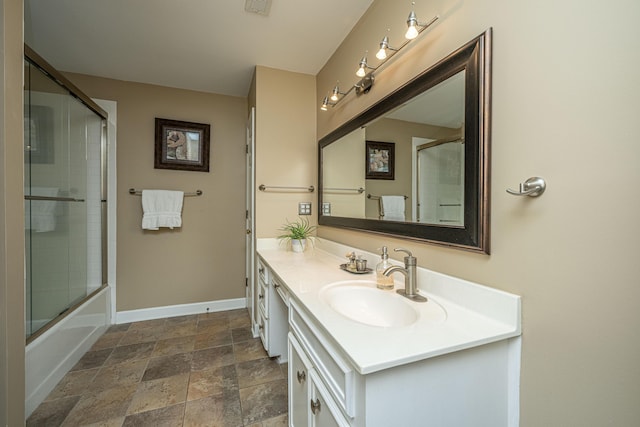 bathroom featuring enclosed tub / shower combo and vanity