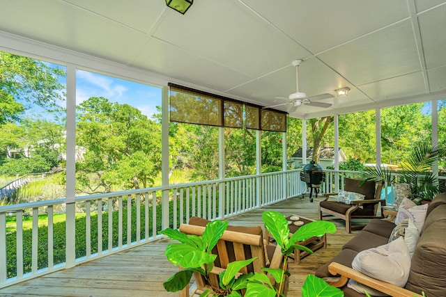 sunroom / solarium featuring ceiling fan