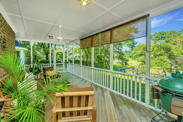 unfurnished sunroom with ceiling fan