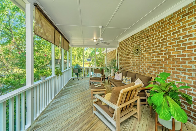 wooden deck with ceiling fan and outdoor lounge area