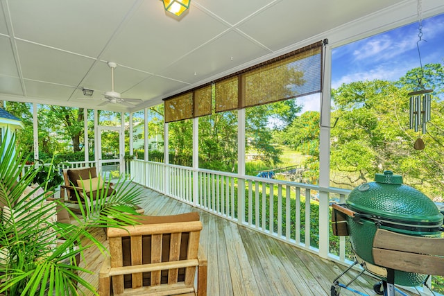 unfurnished sunroom featuring ceiling fan