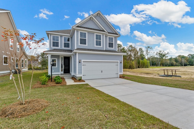 view of front of property featuring a front yard and a garage