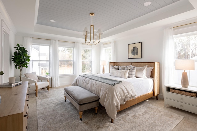 carpeted bedroom with a notable chandelier, wood ceiling, and a tray ceiling