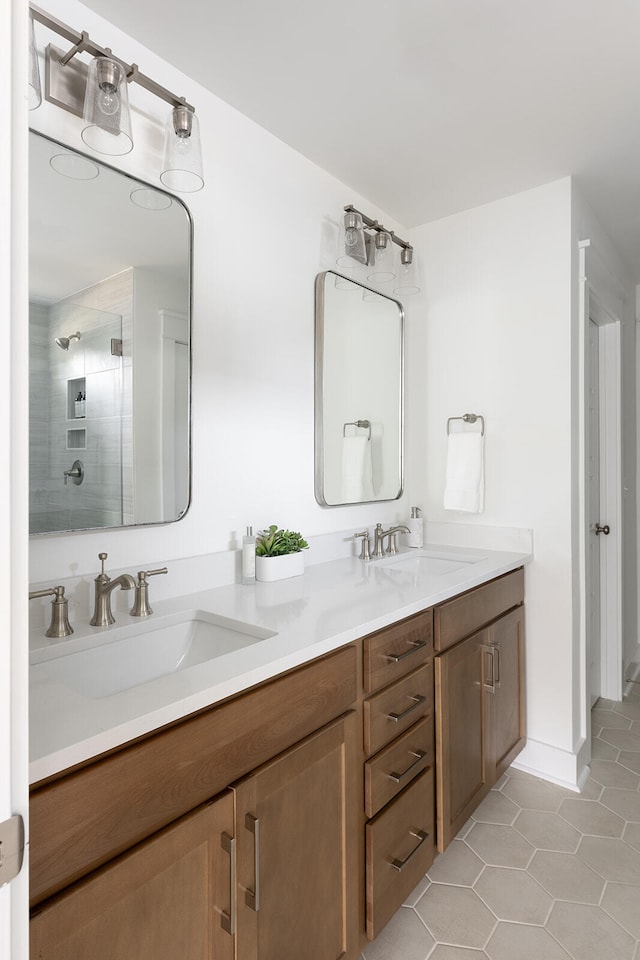 bathroom featuring vanity, tile patterned flooring, and a shower with door