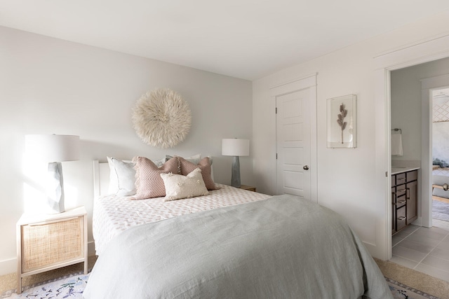 bedroom featuring connected bathroom and tile patterned floors