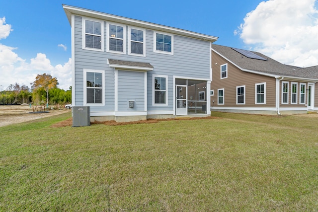 rear view of property with a sunroom and a lawn