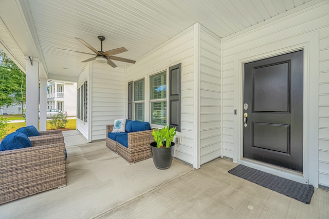 entrance to property featuring a porch and ceiling fan