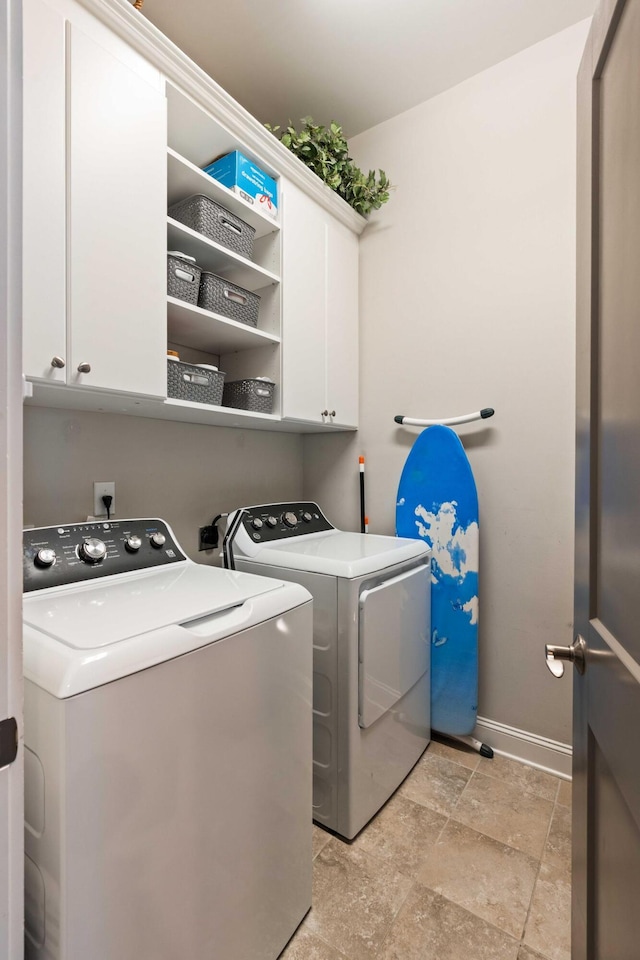 3726 Orion Ln, Mount Pleasant, SC 29466 - washroom featuring cabinet space, washing machine and clothes dryer, light stone finish floors, and baseboards