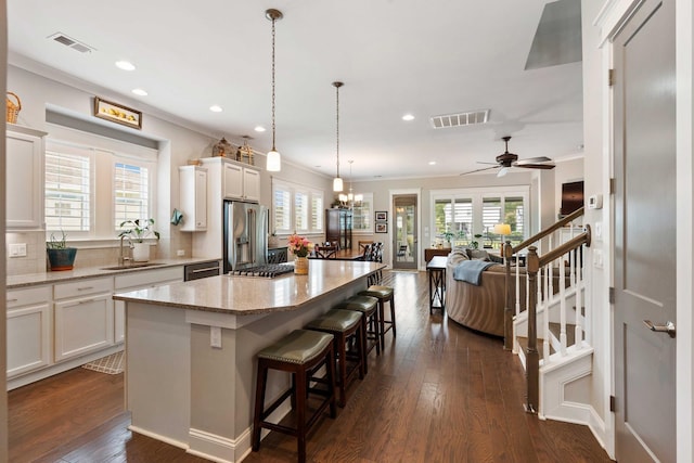 3726 Orion Ln, Mount Pleasant, SC 29466 - kitchen with stainless steel refrigerator with ice dispenser, a sink, plenty of natural light, crown molding, and a center island