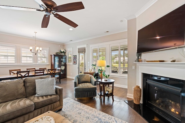3726 Orion Ln, Mount Pleasant, SC 29466 - living room featuring dark wood finished floors, crown molding, a glass covered fireplace, baseboards, and a chandelier