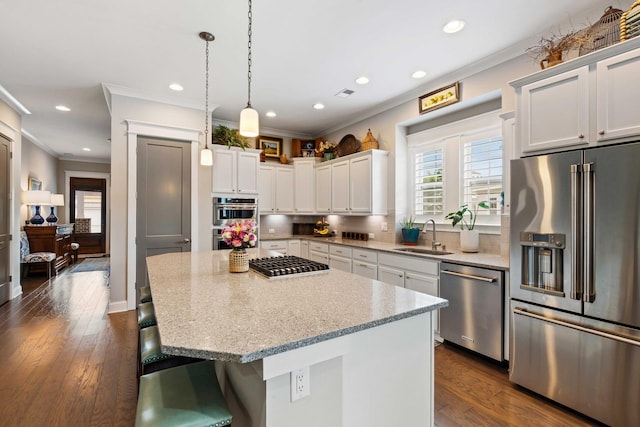 3726 Orion Ln, Mount Pleasant, SC 29466 - kitchen with appliances with stainless steel finishes, a sink, ornamental molding, a breakfast bar area, and white cabinetry