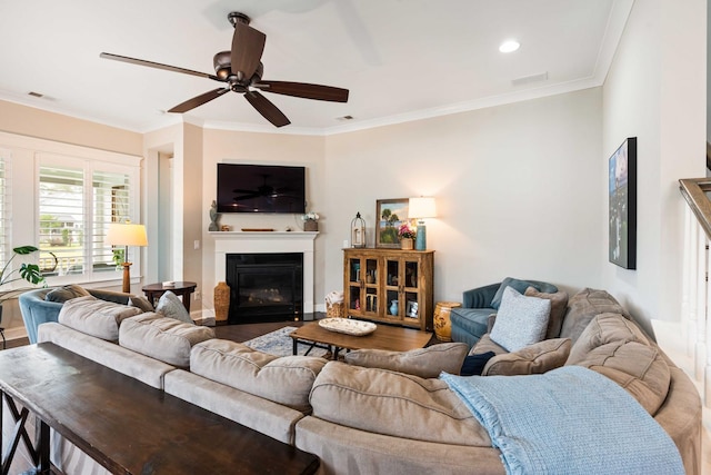 3726 Orion Ln, Mount Pleasant, SC 29466 - living room with a glass covered fireplace, ceiling fan, crown molding, and recessed lighting