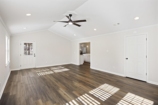 unfurnished living room with vaulted ceiling, ornamental molding, dark wood-style floors, and baseboards