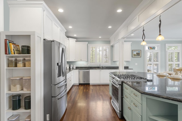 kitchen with stainless steel appliances, plenty of natural light, and crown molding