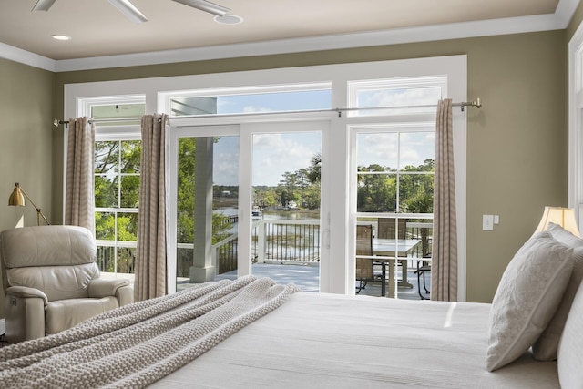 bedroom featuring a water view, recessed lighting, and access to exterior