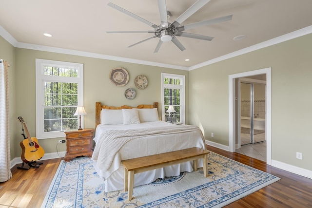 bedroom featuring crown molding, wood finished floors, and baseboards