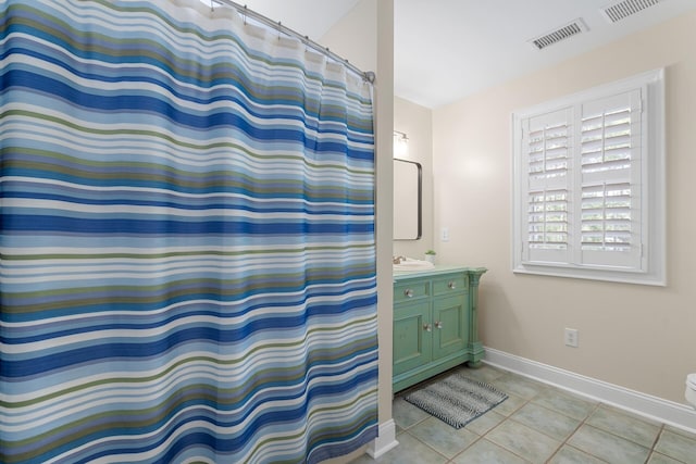 full bath featuring tile patterned floors, vanity, baseboards, and visible vents