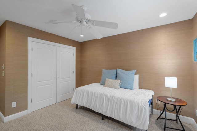 bedroom featuring a closet, baseboards, ceiling fan, recessed lighting, and light carpet