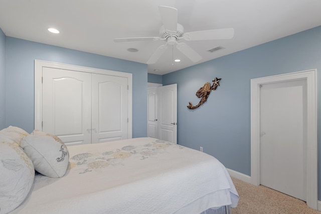 bedroom with visible vents, baseboards, a closet, ceiling fan, and carpet