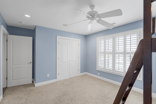 unfurnished bedroom featuring visible vents, baseboards, a closet, and carpet flooring